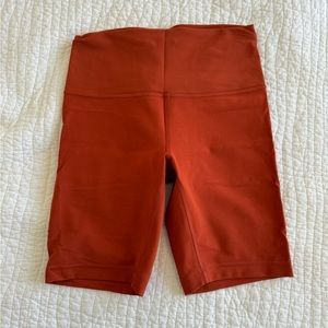 Burnt orange lululemon wunder train bike shorts. Size 8